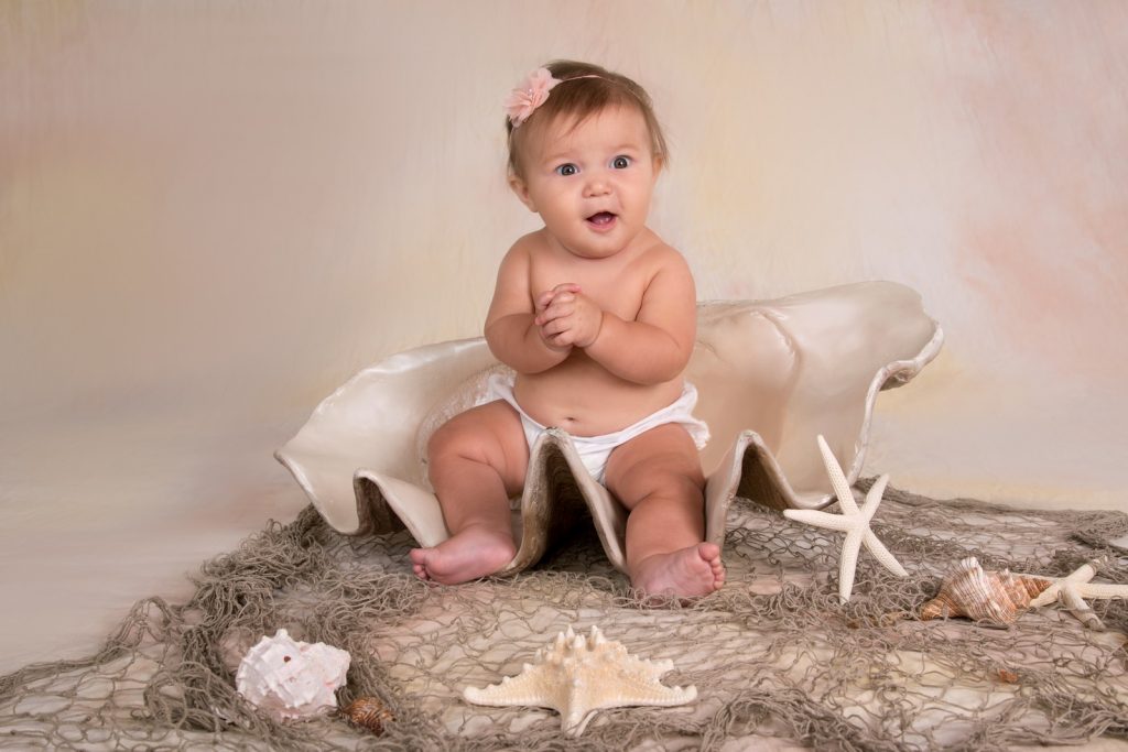 Studio Portrait of a Baby Girl in a Sea Shell Scene