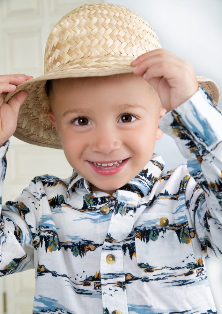 Studio Portrait of a Little Boy in a Straw Hat