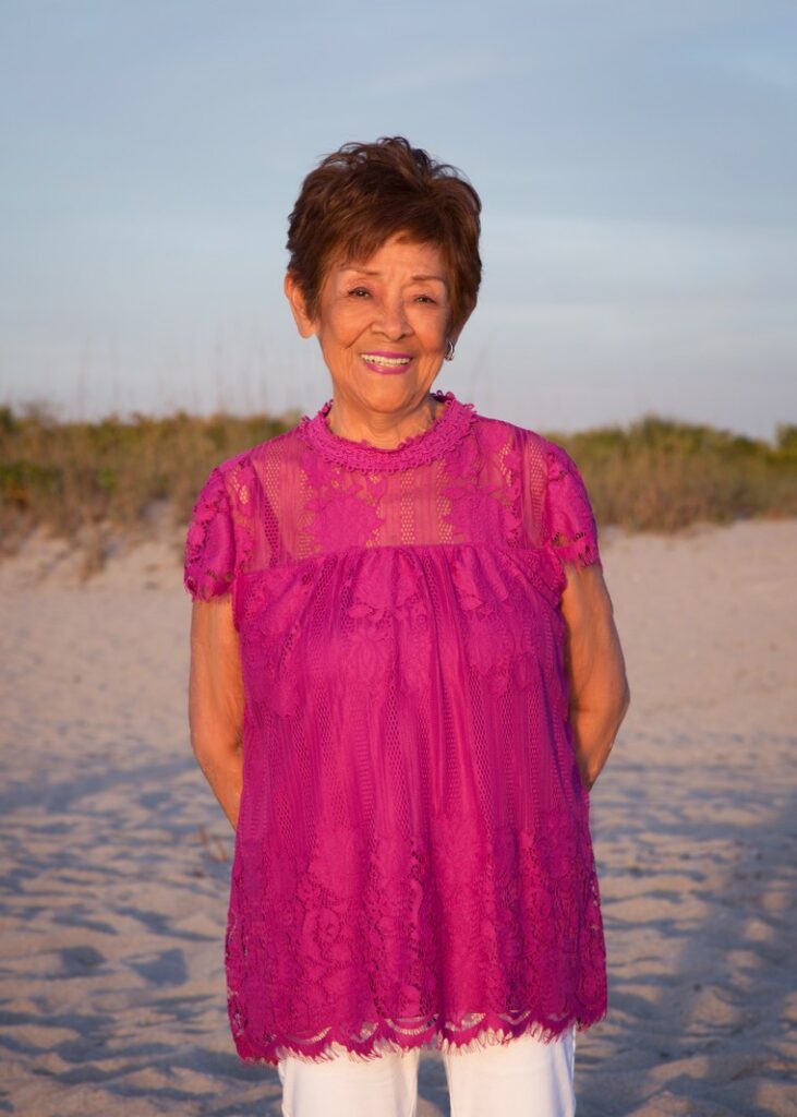 business portrait of a female real estate agent wearing a pink blouse on the beach