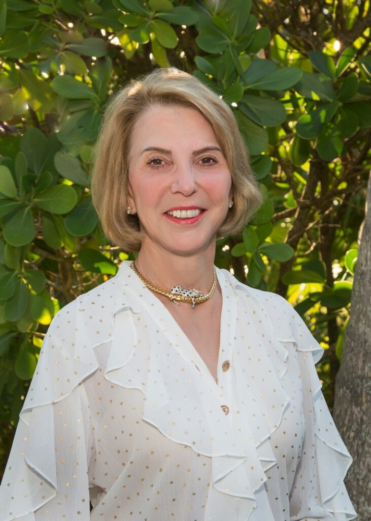 business portrait of a female real estate agent in a white blouse outdoors