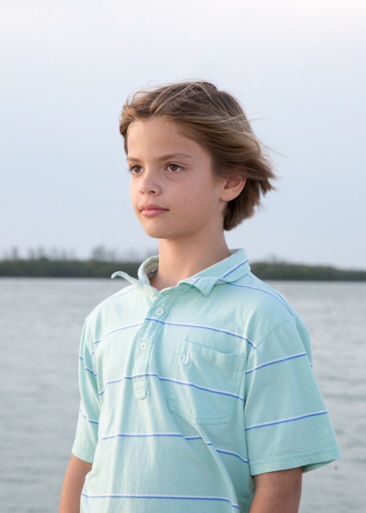 portrait of a preteen boy on the beach