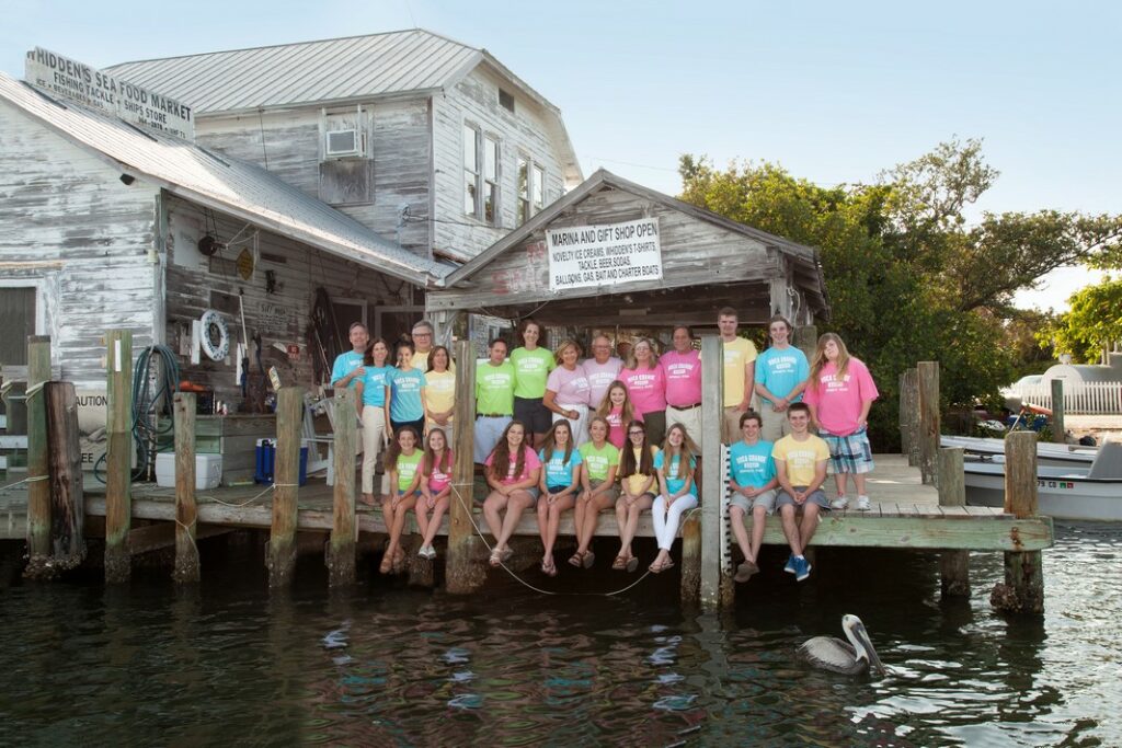portrait of a large family wearing colorful t-shirts at Whidden's Marina in Boca Grande, FL